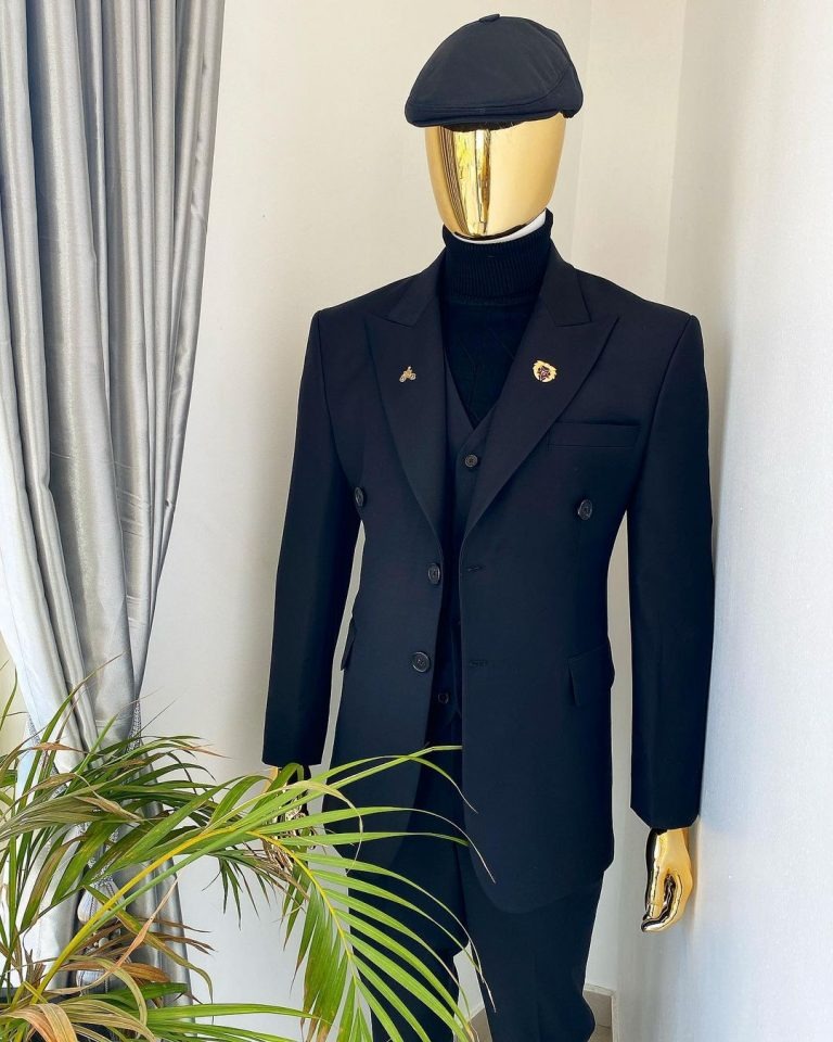 Deji and Kola A charcoal black Bespoke reloaded “Peaky Blinders” peak lapel suit