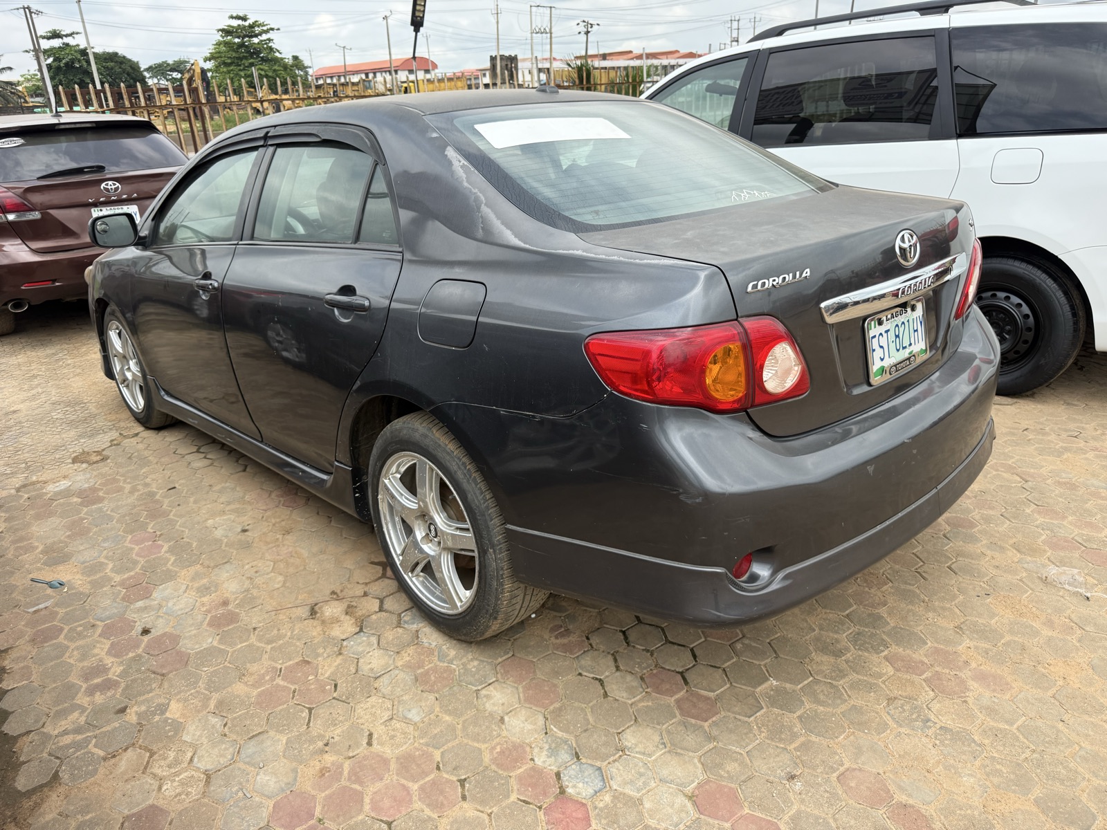 Toyota Corolla, Dark Grey Sedan with Alloy Wheels