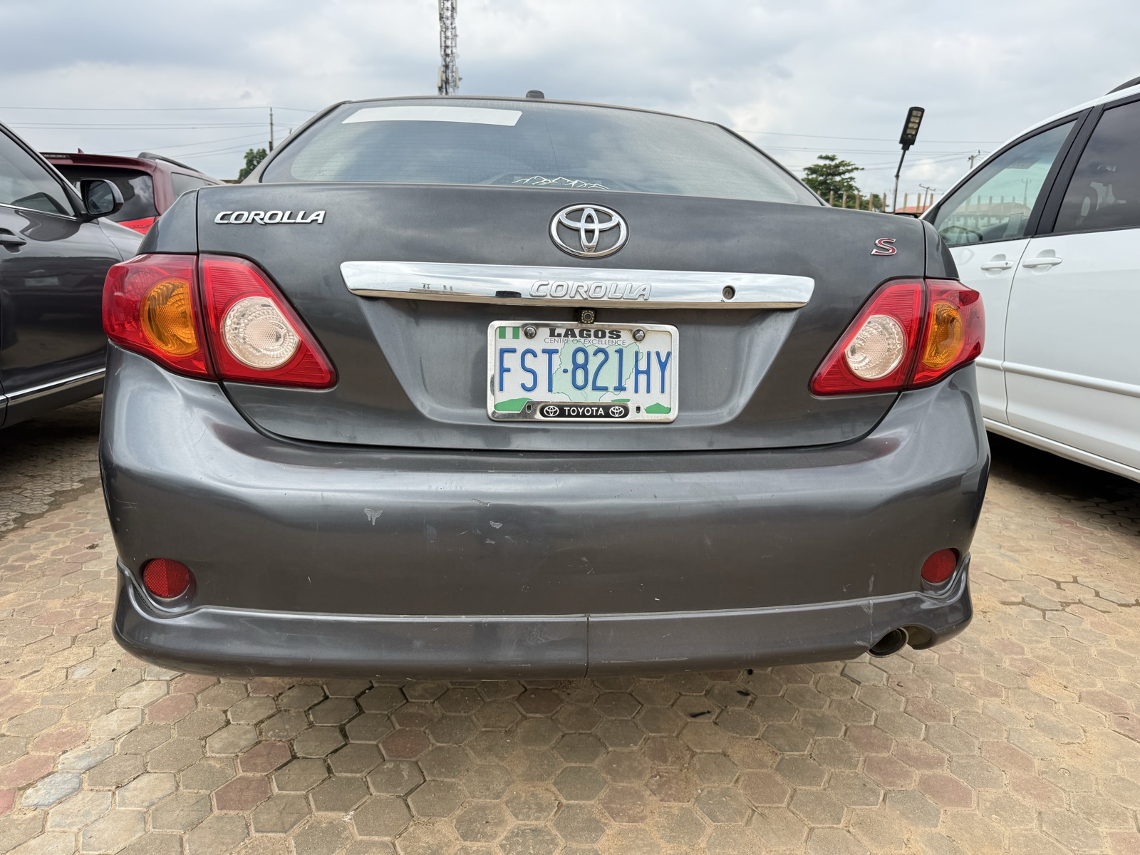 Toyota Corolla, Dark Grey Sedan with Alloy Wheels