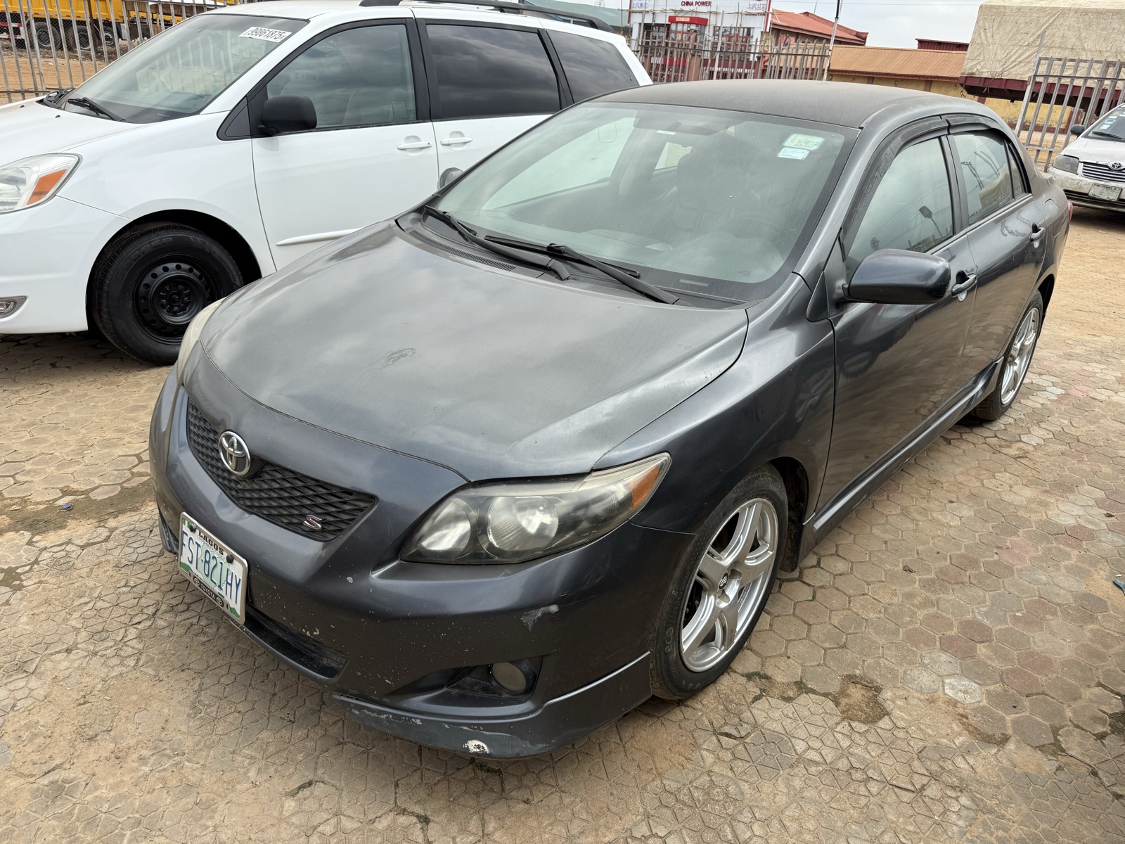 Toyota Corolla, Dark Grey Sedan with Alloy Wheels