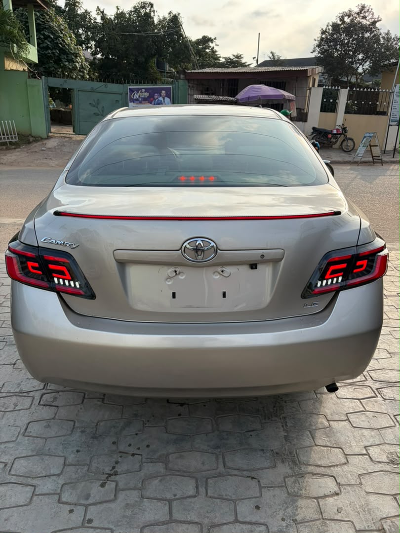 Toyota Camry Gold Sedan with Custom Lights