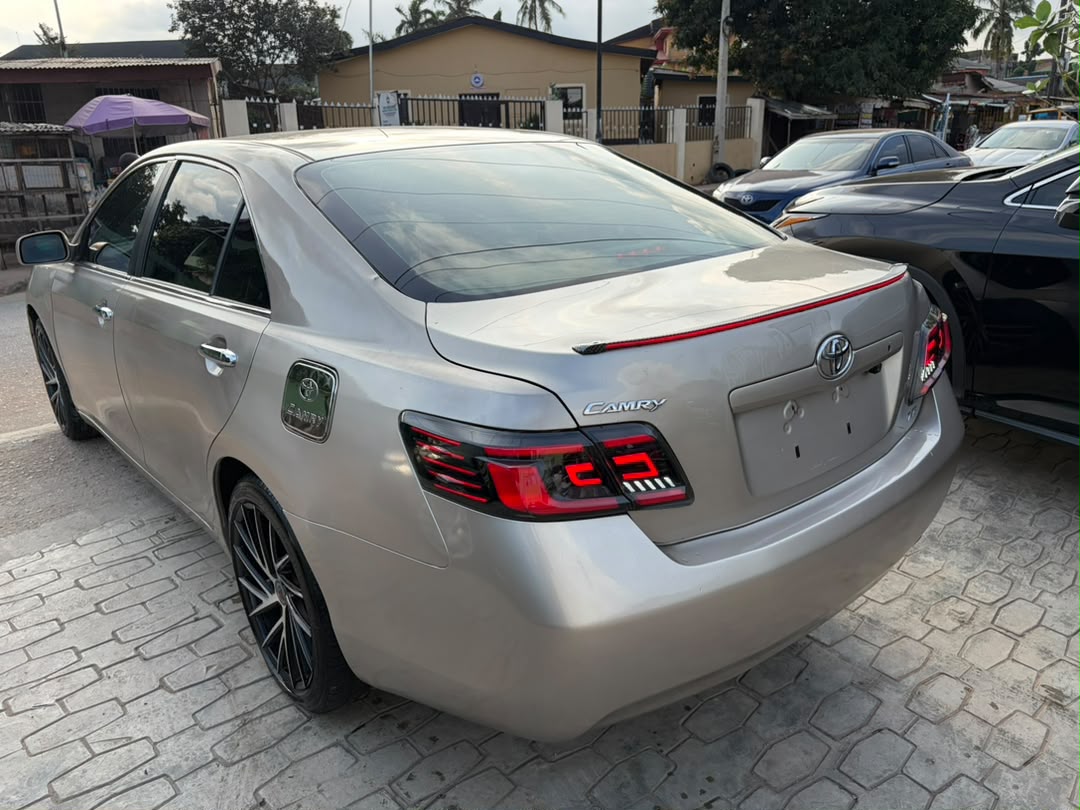 Toyota Camry Gold Sedan with Custom Lights