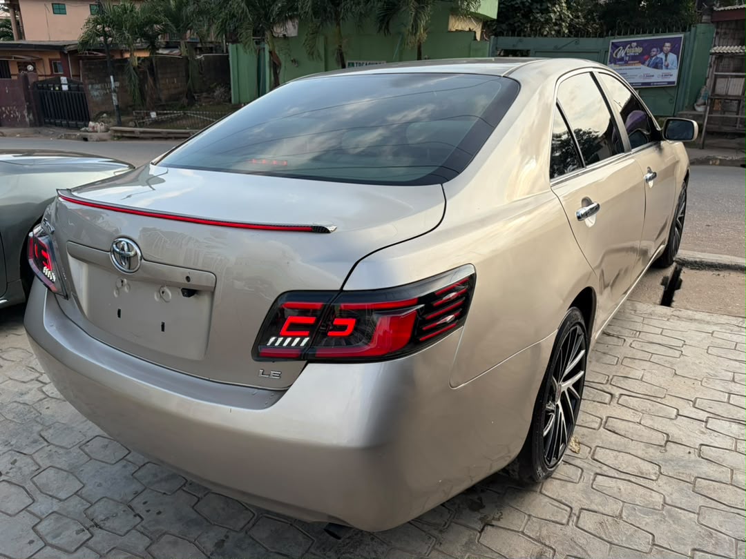 Toyota Camry Gold Sedan with Custom Lights